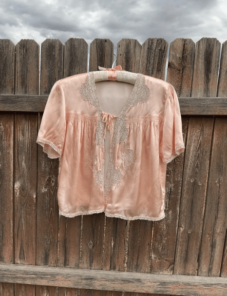 Light pink silk bed jacket.